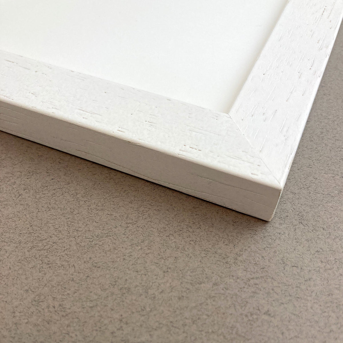 Close-up of the James Ellis white wood picture frame corner