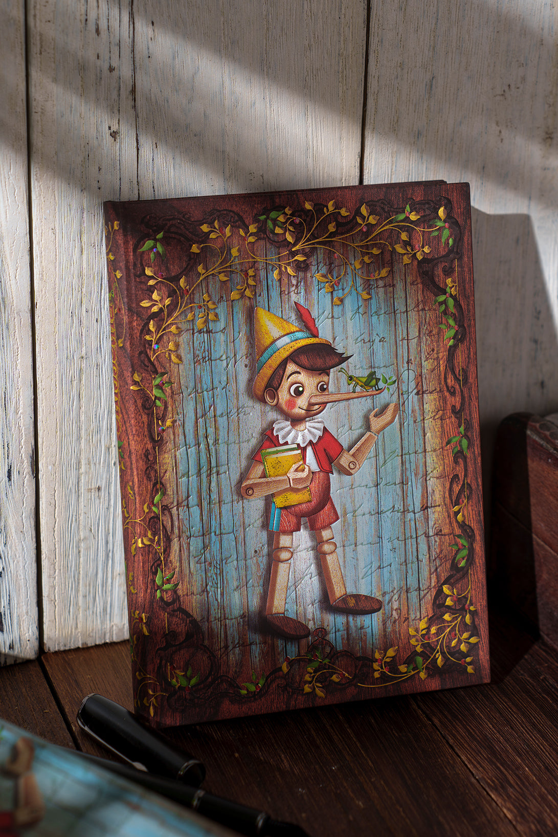 Paperblanks Carlo Collodi, Pinocchio Ultra Hardback Journal – Plain, 144 Pages – lifestyle image