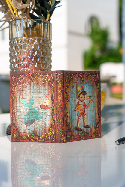 Paperblanks Carlo Collodi, Pinocchio Midi Hardback Journal – Lined, 144 Pages – lifestyle image