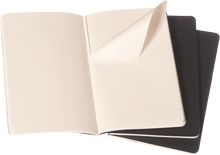 Moleskine pocket black Cahier Journal open showing ruled ivory pages