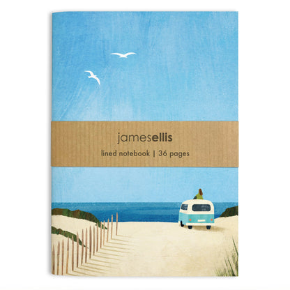 A6 notebook cover with a pale blue campervan on sand dunes facing the sea, a figure sitting on its roof