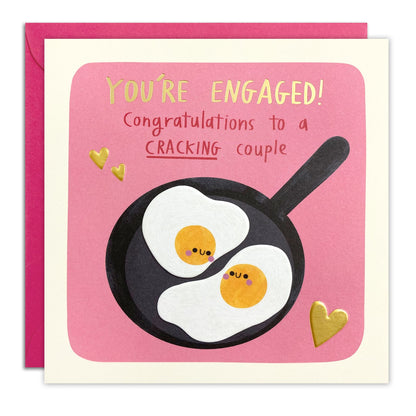 Engagement card of two smiling fried eggs in a pan on pink, 'You're Engaged! Congratulations to a Cracking couple'