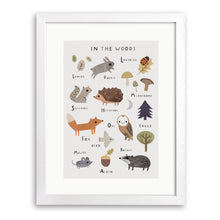 White wood framed print of labelled woodland animals including fox, owl, hedgehog and badger