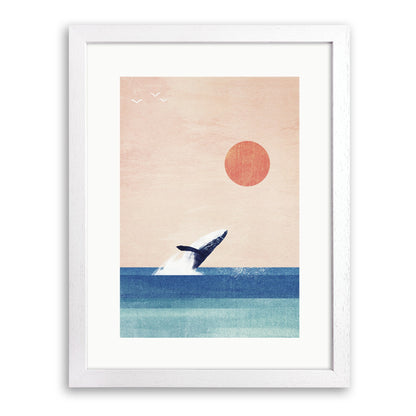 White wood framed print of a humpback whale breaching from a blue sea under a peach sky and red sun